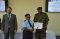 A course participant receives a certificate of completion from HPSS Commandant as GIZ Program Leader looks on