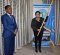 The Deputy Head of Mission Ms. Lina Peggy Hoareau receives the organization's flag, signifying the team's readiness to roll out and accomplish the upcoming mission.  